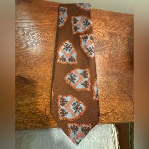 Brown Tie with Orange and Blue Shield Pattern